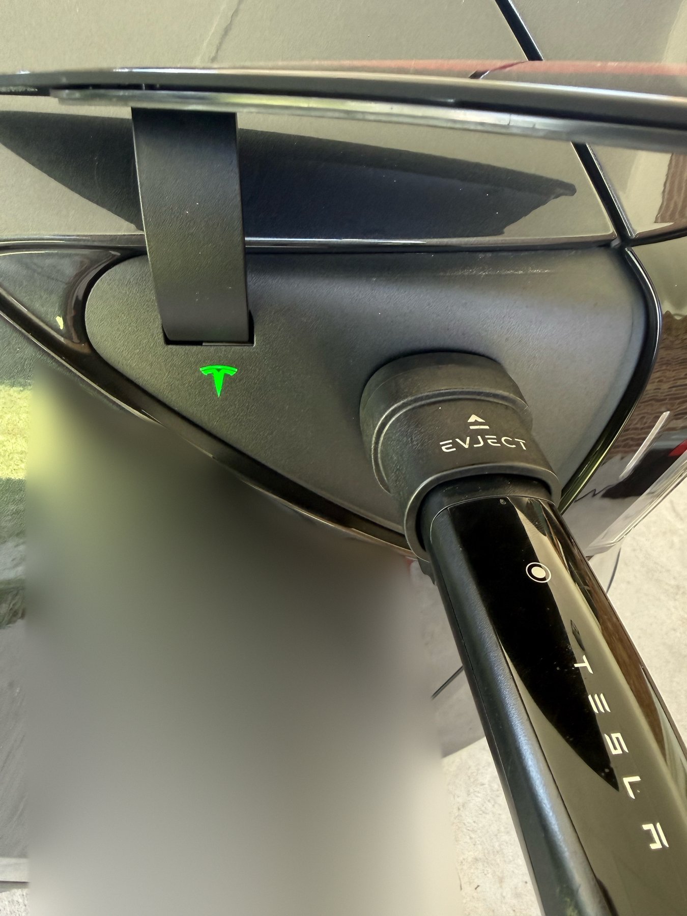 EVject Escape Connector 2.0 on a Tesla charge port with the port light glowing green