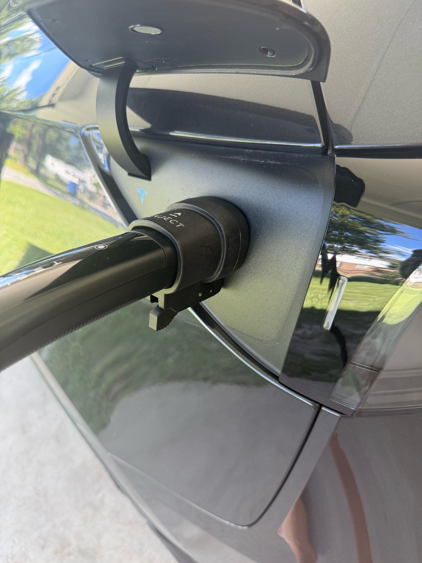 EVject Escape Connector 2.0 plugged into a Tesla charge port with the charging handle attached